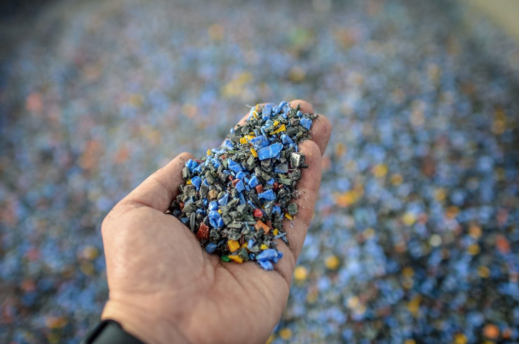 Hand-with-shredded-plastic-waste