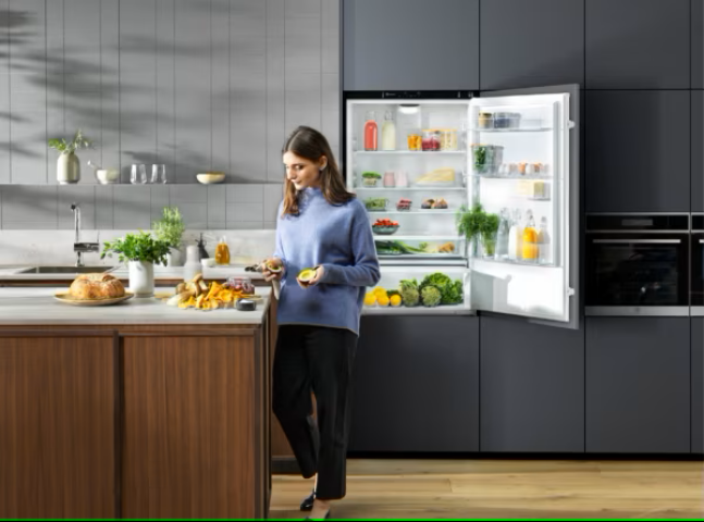 open refridgerator with woman in kitchen